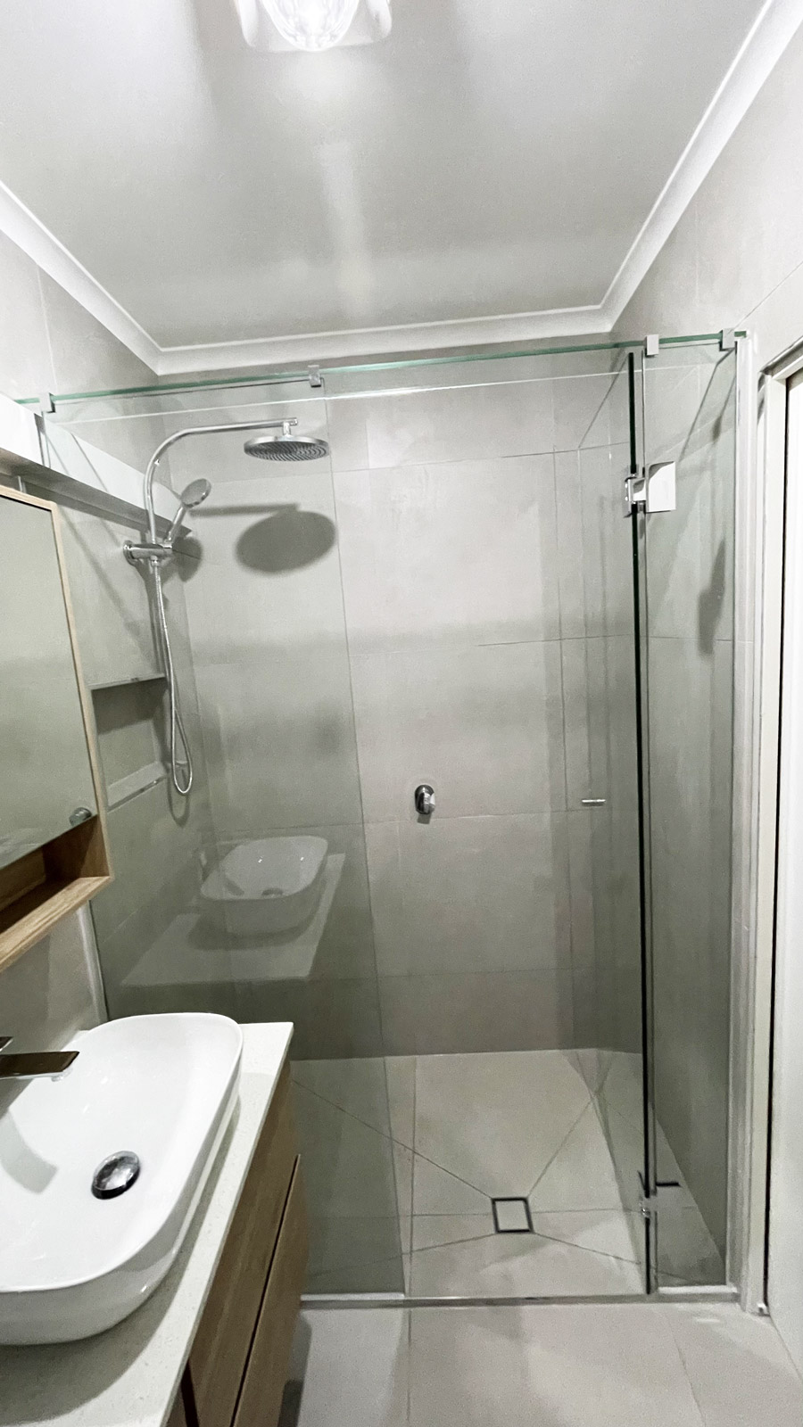 Fully renovated ensuite bathroom in Ormond by Sealed Trading, featuring modern tiles, glass shower screen, and updated fixtures.