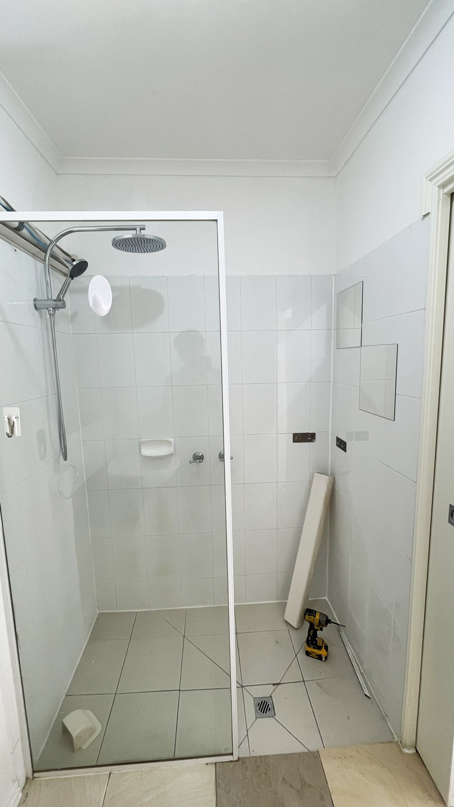 Outdated ensuite bathroom in Ormond before renovation by Sealed Trading, featuring old tiles and dated fixtures.