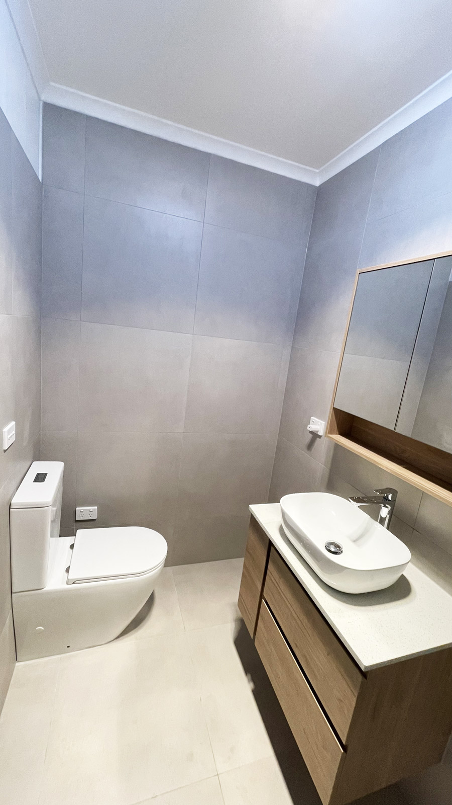 Modern ensuite bathroom in Ormond, renovated by Sealed Trading Dandenong, featuring new tiles, sleek fixtures, and a refreshed layout.