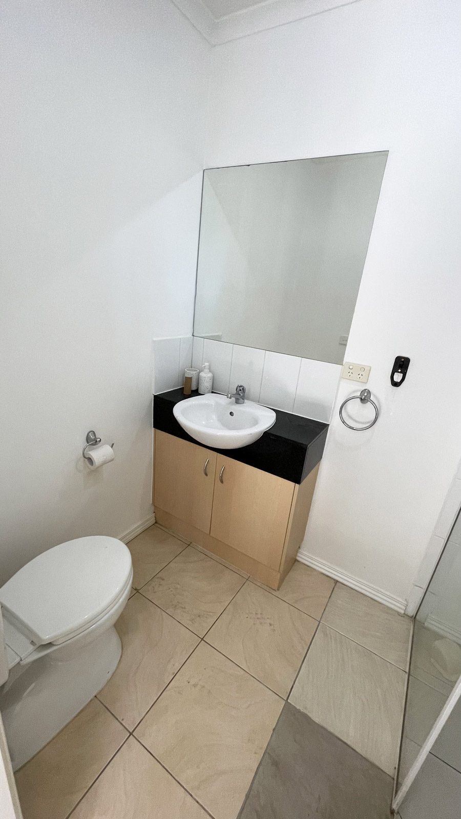 Ensuite bathroom in Ormond before renovation by Sealed Trading Dandenong, showing outdated tiles, old fixtures, and original layout.